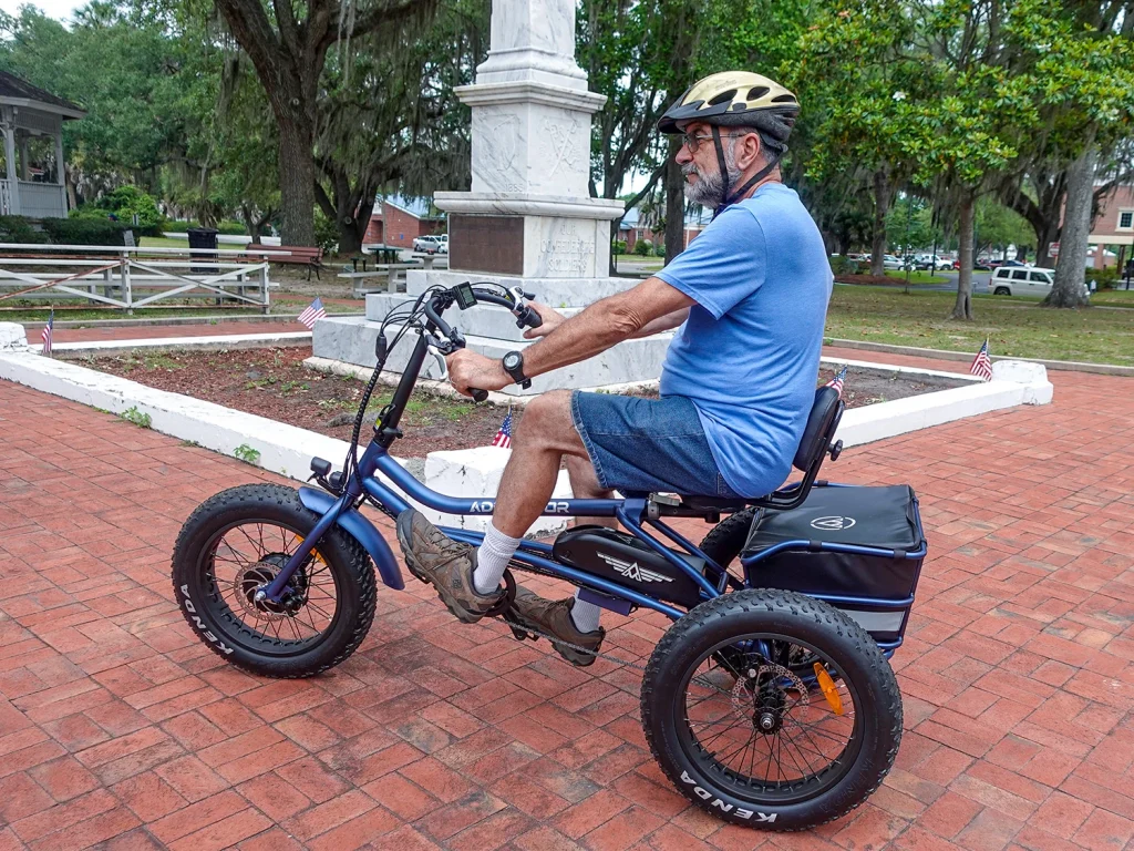 Man using an electric-assist tricycle