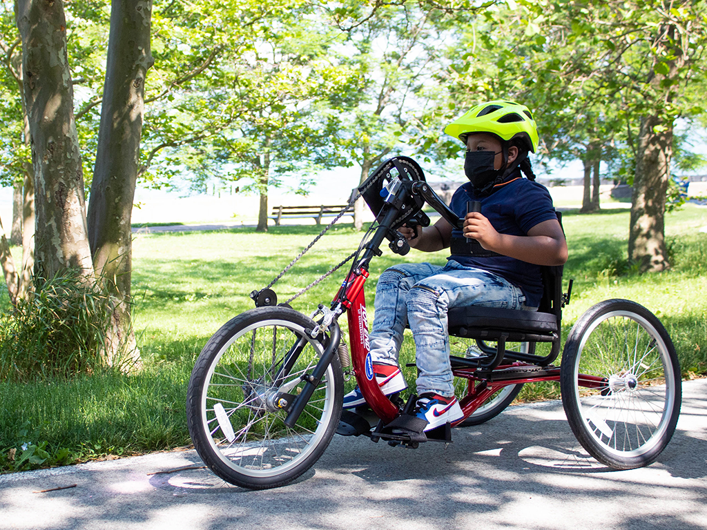 Young person using a hand-cycle bike for exercise