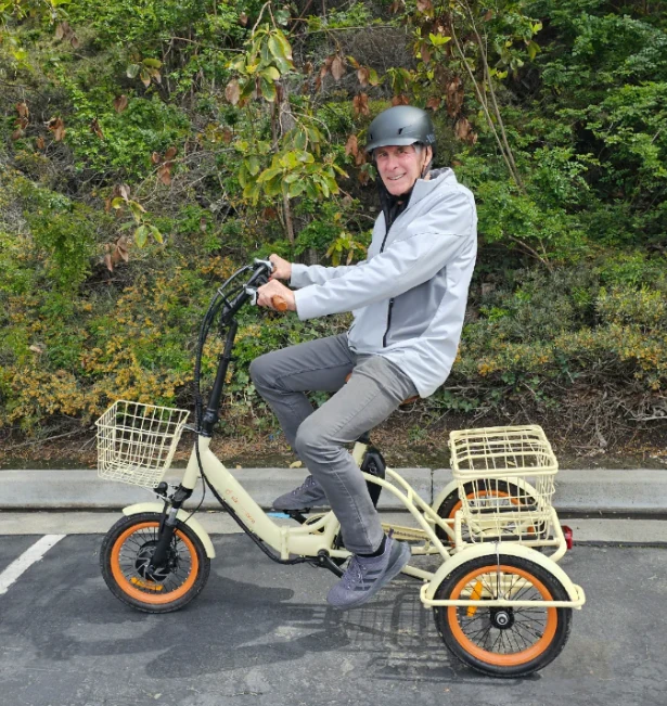 man using an upright tricycle with two wheels in the front and one wheel in the back