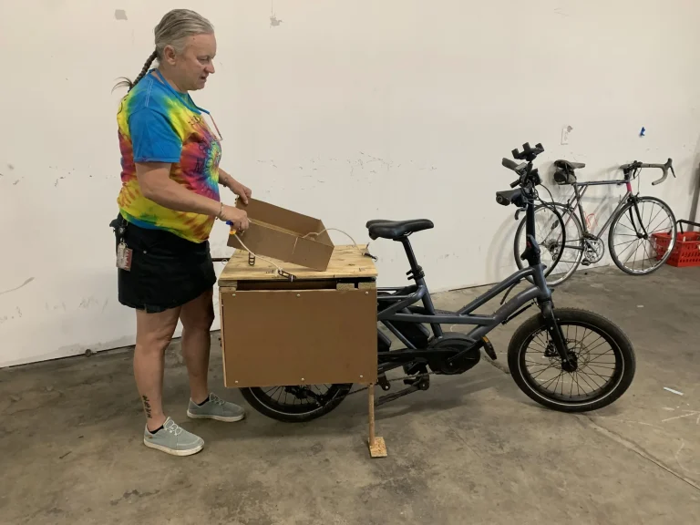 Rebecca with an early prototype of her e-cargo bike for bikeshare operations, inspired by her research