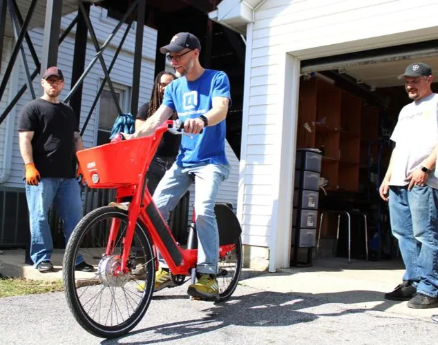 Tomorrow's Neighbors Director Kurt Kanysh riding an e-bike