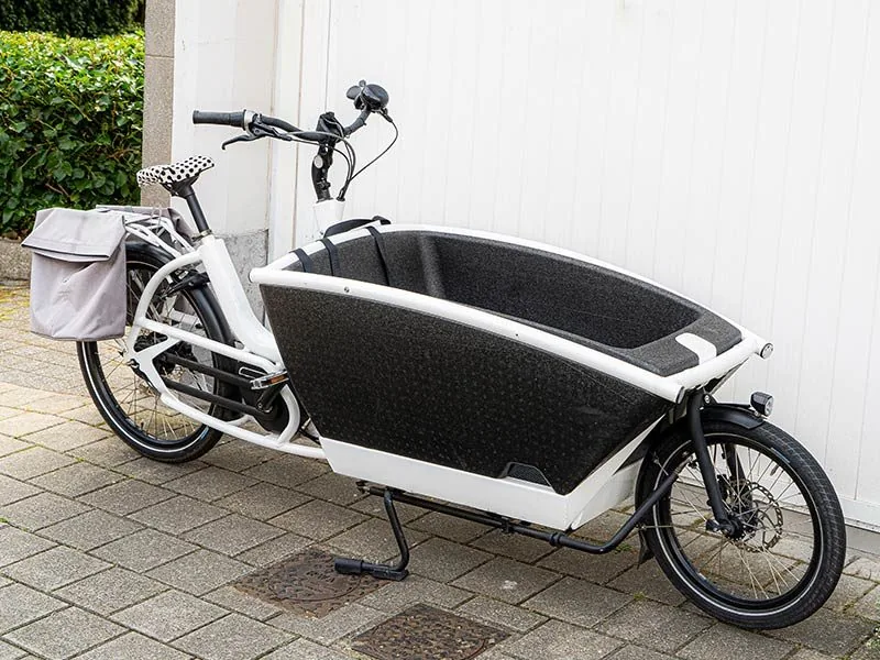 A white cargo e-bike with a front box