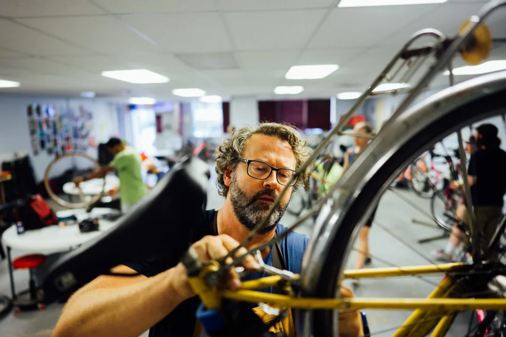 Danilo Lawvere fixing a bike at Eastside Bike Club's bike build-up