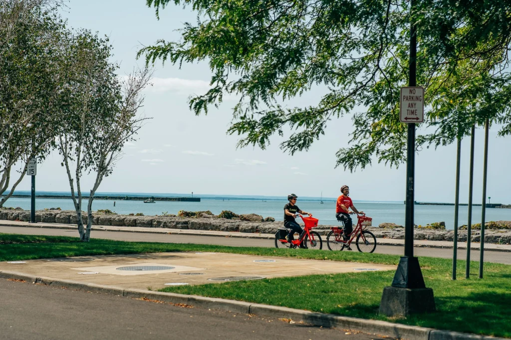 Reddy Bikeshare's Marketing & Communication Coordinator Simon Husted and M&T Bank's AJ enjoying a ride down Buffalo's Waterfront using Reddy's pedal bike and pedal-assisted e-bike.