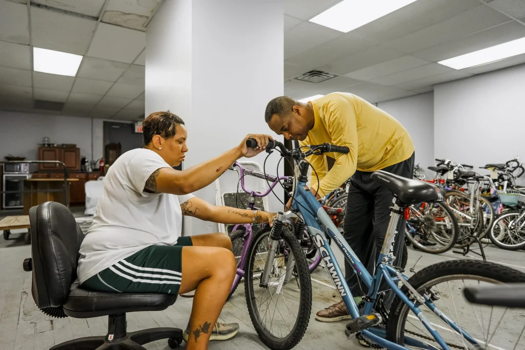 Community members working on bikes in East Side Bike Club's Community workshop.