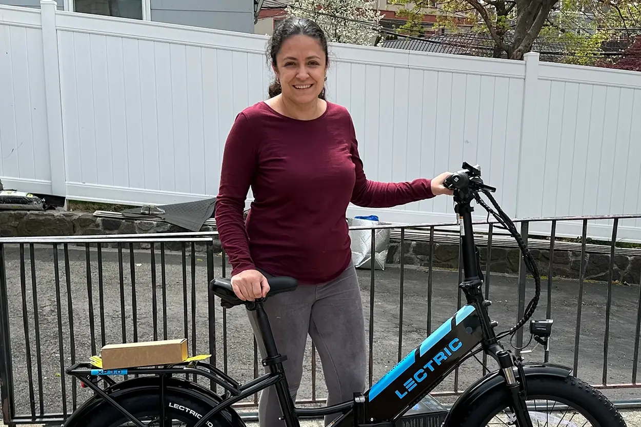 An e-bike owner with their rebate-funded bike